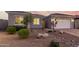 Well-maintained front yard with desert landscaping, decorative rocks, and mature trees enhancing curb appeal at 17721 W Sandalwood Dr, Goodyear, AZ 85338