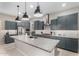 Modern kitchen featuring stainless steel appliances, granite countertops, a spacious island, and stylish pendant lighting at 17721 W Sandalwood Dr, Goodyear, AZ 85338