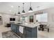 Modern kitchen with large island, granite countertops, stainless steel appliances, and an open floorplan at 17721 W Sandalwood Dr, Goodyear, AZ 85338
