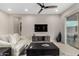 Well-lit living room features a modern entertainment center, ceiling fan, and patio access at 17721 W Sandalwood Dr, Goodyear, AZ 85338