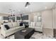 Open-concept living area flows into the kitchen, with a neutral color palette, modern lighting, and stylish furniture at 17721 W Sandalwood Dr, Goodyear, AZ 85338