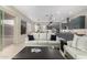 Open-concept living room with modern accents, a cozy sofa, and kitchen access at 17721 W Sandalwood Dr, Goodyear, AZ 85338