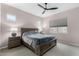 Relaxing primary bedroom with plush carpeting, a ceiling fan, and large windows providing natural light at 17721 W Sandalwood Dr, Goodyear, AZ 85338