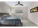 Bright main bedroom with carpet flooring, a ceiling fan, and a large cozy bed at 17721 W Sandalwood Dr, Goodyear, AZ 85338