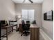 Functional home office includes a spacious desk, ceiling fan, and ample natural light at 17721 W Sandalwood Dr, Goodyear, AZ 85338