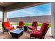 Comfortable patio features red cushioned chairs and a modern fire pit at 17721 W Sandalwood Dr, Goodyear, AZ 85338