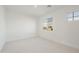 Bright bedroom features neutral carpet, white walls, recessed lighting and a view of the surrounding neighborhood at 19015 W Rose Ln, Waddell, AZ 85355