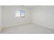 Bedroom with neutral carpet, recessed lighting, and window overlooking neighborhood at 19015 W Rose Ln, Waddell, AZ 85355