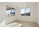 Bright dining room featuring a modern chandelier and large windows at 19015 W Rose Ln, Waddell, AZ 85355