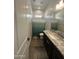 Bathroom featuring a stylish vanity with a granite countertop, a shower with a patterned curtain, and tiled flooring at 19929 W Marshall Ave, Litchfield Park, AZ 85340