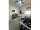 Light-filled Bedroom features gray carpet, crib, dinosaur-themed decor and ceiling fan at 19929 W Marshall Ave, Litchfield Park, AZ 85340