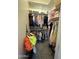 Walk-in closet providing ample storage with organized shelving, multiple hanging rods, and a variety of clothing and accessories at 19929 W Marshall Ave, Litchfield Park, AZ 85340