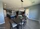 Dining area and kitchen view with decorative lights and a modern table set at 19929 W Marshall Ave, Litchfield Park, AZ 85340