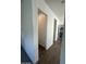 Bright and neutral hallway with doors leading to a powder room and laundry room at 19929 W Marshall Ave, Litchfield Park, AZ 85340