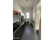 Well-lit laundry room with washer, dryer, and stylish black and white patterned floor tiling at 19929 W Marshall Ave, Litchfield Park, AZ 85340