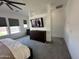 Calming main bedroom with a neutral color palette, carpet, and a wall-mounted TV above the dresser at 19929 W Marshall Ave, Litchfield Park, AZ 85340