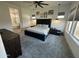 The main bedroom includes a large, comfortable bed, ceiling fan and windows that let in natural light at 19929 W Marshall Ave, Litchfield Park, AZ 85340