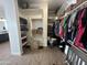 Well-organized walk-in closet featuring open shelving, hanging rods, and convenient storage solutions at 19929 W Marshall Ave, Litchfield Park, AZ 85340