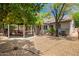Backyard featuring lush trees with a gazebo, a grill, and a patio set for relaxing outdoors at 20044 N 30Th Pl, Phoenix, AZ 85050