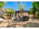 Landscaped backyard featuring a gazebo with a grill and seating area under a clear blue sky at 20044 N 30Th Pl, Phoenix, AZ 85050