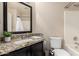 Bathroom with granite counters, dark wood cabinets, toilet, shower and tub combination, and a framed mirror at 20044 N 30Th Pl, Phoenix, AZ 85050
