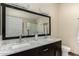 Bathroom with dual sinks, a glass-enclosed shower, and a white marble countertop at 20044 N 30Th Pl, Phoenix, AZ 85050