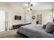 Well-lit bedroom with a bed, a ceiling fan, and an ensuite bathroom at 20044 N 30Th Pl, Phoenix, AZ 85050