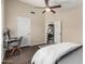 Bedroom with a desk, a ceiling fan, tiled floors, and a view of the living room at 20044 N 30Th Pl, Phoenix, AZ 85050