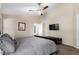 Cozy bedroom with a king-size bed, ceiling fan, and stylish furnishings at 20044 N 30Th Pl, Phoenix, AZ 85050