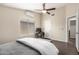 Bright bedroom featuring hardwood floors, a ceiling fan, a workstation with a computer, and neutral paint at 20044 N 30Th Pl, Phoenix, AZ 85050