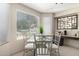 Bright dining area featuring large windows, a glass table, and neutral decor at 20044 N 30Th Pl, Phoenix, AZ 85050
