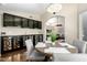 Bright dining room featuring modern chandelier and black display cabinets at 20044 N 30Th Pl, Phoenix, AZ 85050