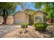 Exterior elevation featuring a two-car garage with low maintenance landscaping at 20044 N 30Th Pl, Phoenix, AZ 85050