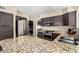 Updated kitchen with stainless steel appliances, granite countertops, and dark cabinets at 20044 N 30Th Pl, Phoenix, AZ 85050