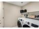Bright laundry room featuring new washer and dryer units and ample shelf space at 20044 N 30Th Pl, Phoenix, AZ 85050