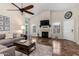 Spacious living room with a fireplace, ceiling fan, and lots of natural light at 20044 N 30Th Pl, Phoenix, AZ 85050