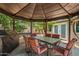 Charming covered patio with dining table and BBQ, perfect for outdoor entertaining in a private backyard oasis at 20044 N 30Th Pl, Phoenix, AZ 85050