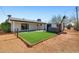 Spacious backyard featuring a shed, jacuzzi, and well-manicured green turf area for outdoor enjoyment at 2204 E Birchwood Ave, Mesa, AZ 85204