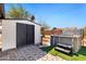 Backyard showcasing shed, jacuzzi and paved area, creating an ideal relaxation and storage space at 2204 E Birchwood Ave, Mesa, AZ 85204