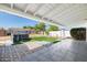 Backyard showcasing a hot tub on artificial turf, a storage shed, and a covered patio at 2204 E Birchwood Ave, Mesa, AZ 85204