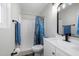 Bathroom featuring modern vanity, toilet and shower/tub combo with blue patterned shower curtain at 2204 E Birchwood Ave, Mesa, AZ 85204