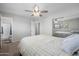 Bright main bedroom with a ceiling fan, carpet flooring and sliding closet doors at 2204 E Birchwood Ave, Mesa, AZ 85204