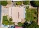 Overhead shot displaying the home's layout, tile roof, landscaping, and private backyard with mature trees at 2258 N Gentry --, Mesa, AZ 85213