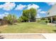 Spacious backyard boasts lush green grass, mature trees, and a playground, perfect for outdoor enjoyment at 2258 N Gentry --, Mesa, AZ 85213