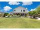A well-manicured backyard with a pristine lawn, blooming flowers, and a covered patio for relaxation at 2258 N Gentry --, Mesa, AZ 85213