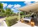 Inviting covered patio with dining area overlooking a lush backyard with mature trees and play area at 2258 N Gentry --, Mesa, AZ 85213