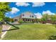 Large backyard features green grass, a play slide and mature landscaping surrounding the property at 2258 N Gentry --, Mesa, AZ 85213