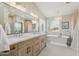 Elegant bathroom with dual sinks, quartz countertops, standalone tub, and modern lighting fixtures at 2258 N Gentry --, Mesa, AZ 85213