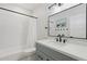 Well-lit bathroom featuring a modern vanity, stylish mirror, and shower with sleek black hardware at 2258 N Gentry --, Mesa, AZ 85213
