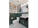 Eclectic bathroom with dark green wainscoting, unique fixtures, and gallery wall at 2258 N Gentry --, Mesa, AZ 85213